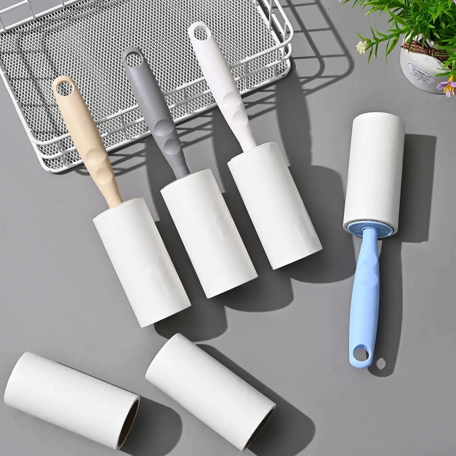 Lint roller with replaceable refills; set of 4 rollers with pastel beige, gray, white, and blue handles