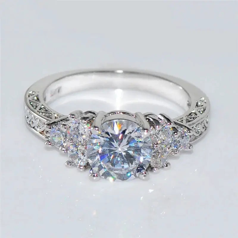 Elegant silver engagement ring with a large central round white zircon and side stones