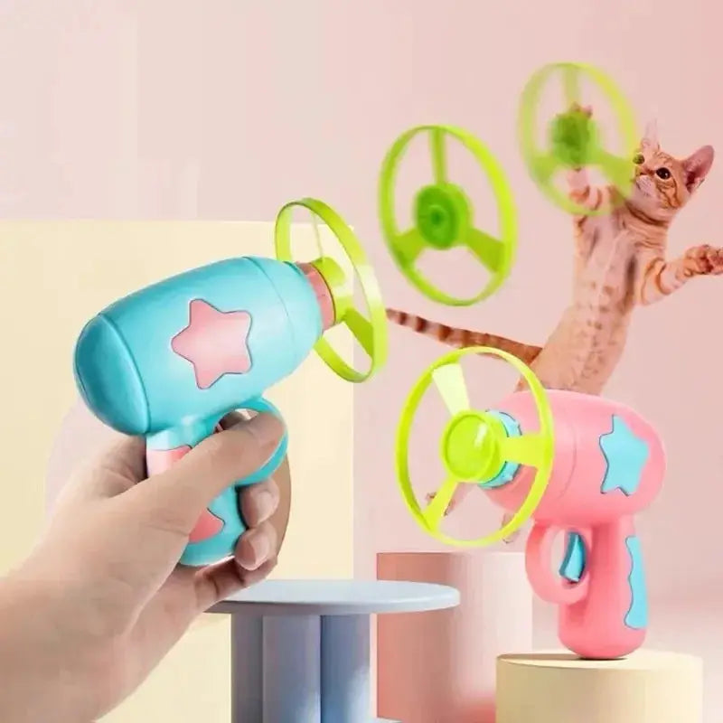 Interactive cat toy gun in blue and pink with neon-green flying discs by Simples Market