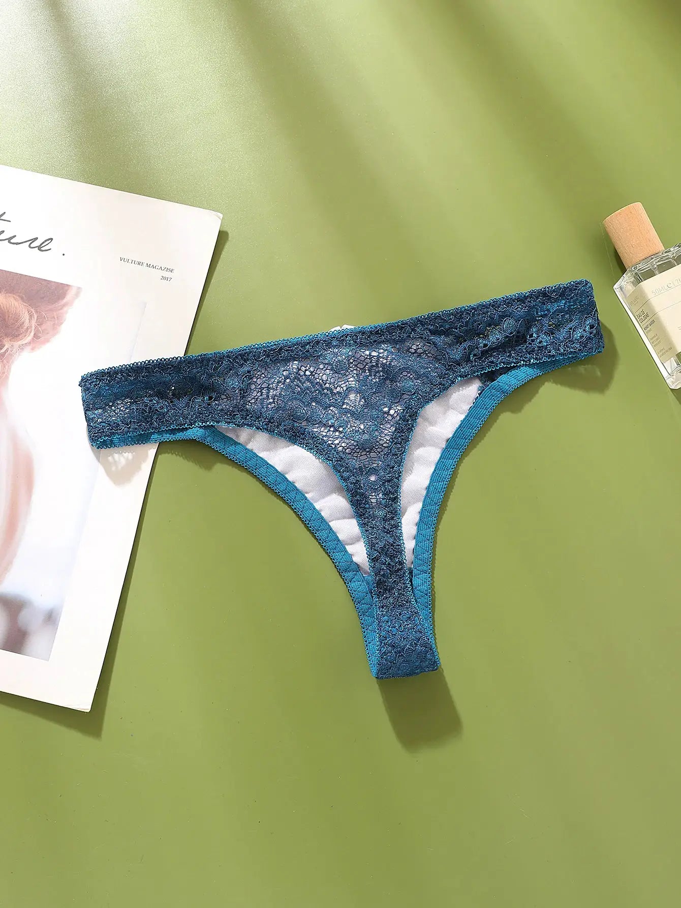 G-string panty in teal lace with sheer floral pattern and light lining