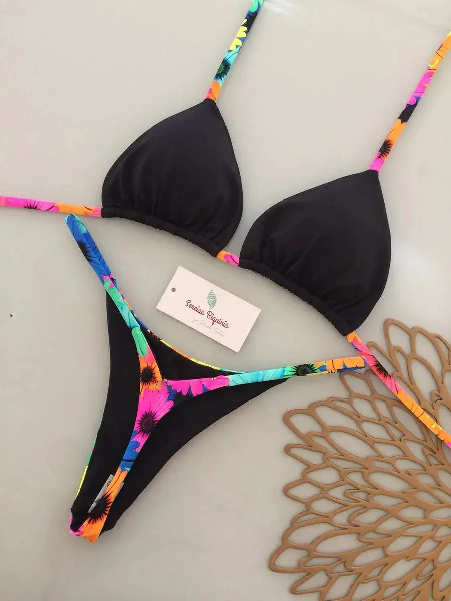 Two-piece micro bikini set with black triangle cups and tropical-print straps