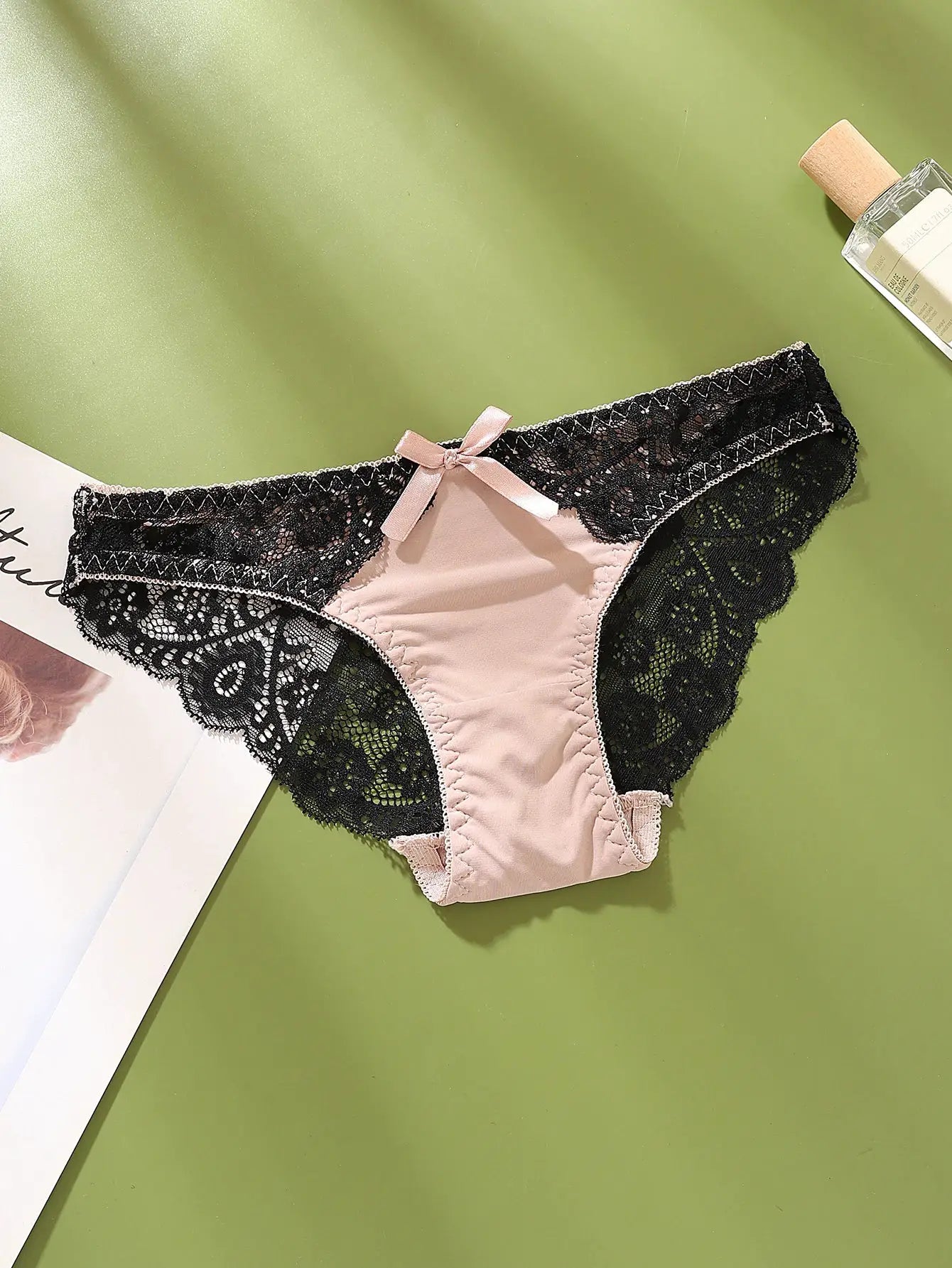 Sexy lace women's underwear with beige center panel and black lace sides, pink bow, mid-low rise briefs.