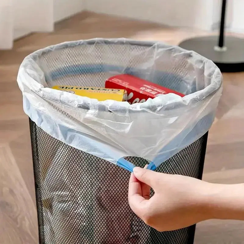 Drawstring thickened large garbage bag for household use in a metal trash can with blue drawstring closure