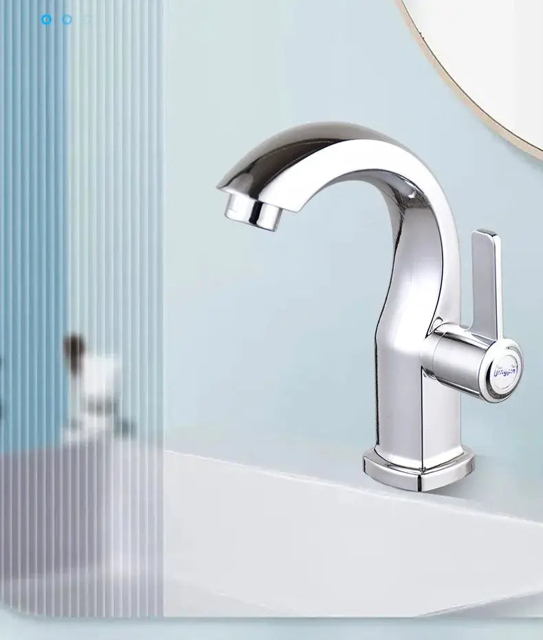 Chrome bathroom basin faucet with single lever, deck-mounted curved spout.