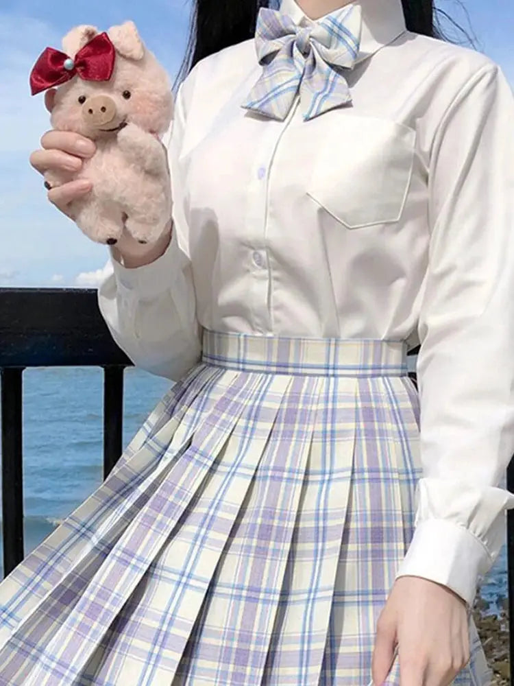 ZOKI plaid pleated high-waist skirt with pastel blue and lavender plaid, shown with white blouse and bow.