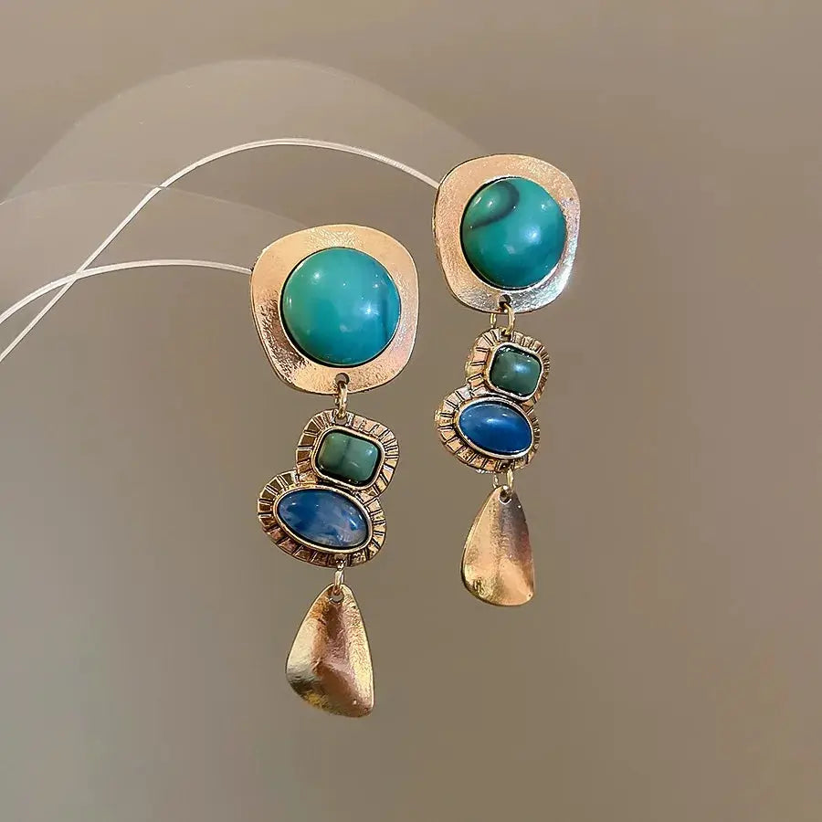 Pair of vintage gold-tone geometric drop earrings with teal resin cabochons and blue stones; gold teardrop charms