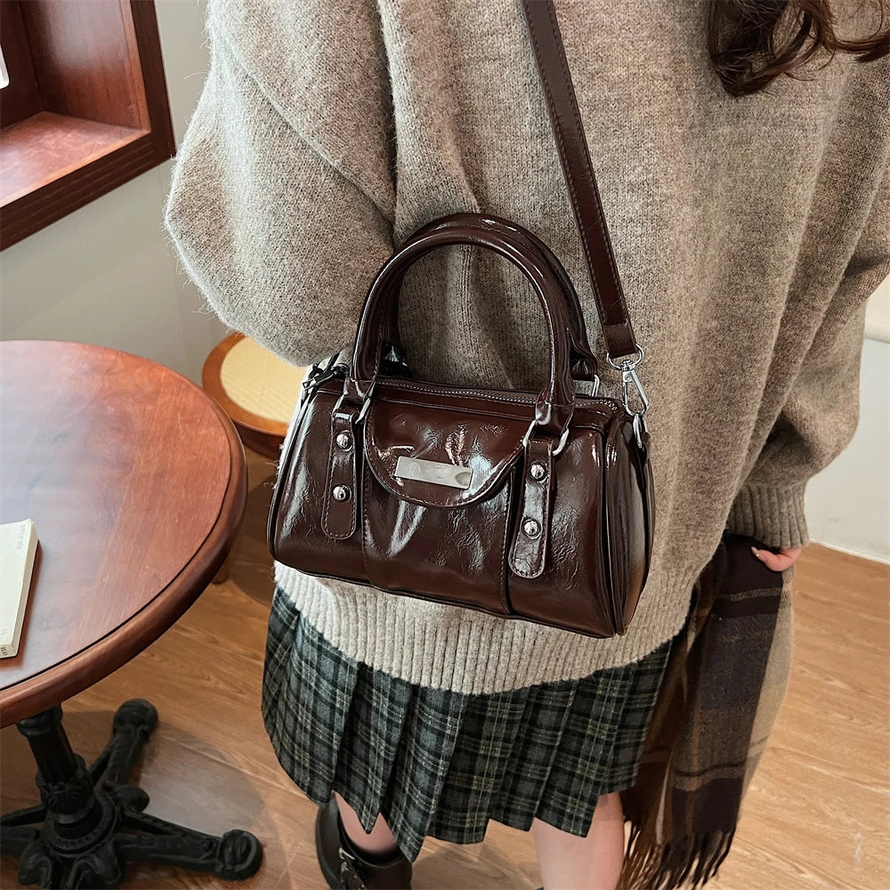 Mini burgundy top-handle bag in glossy PU leather with crossbody strap
