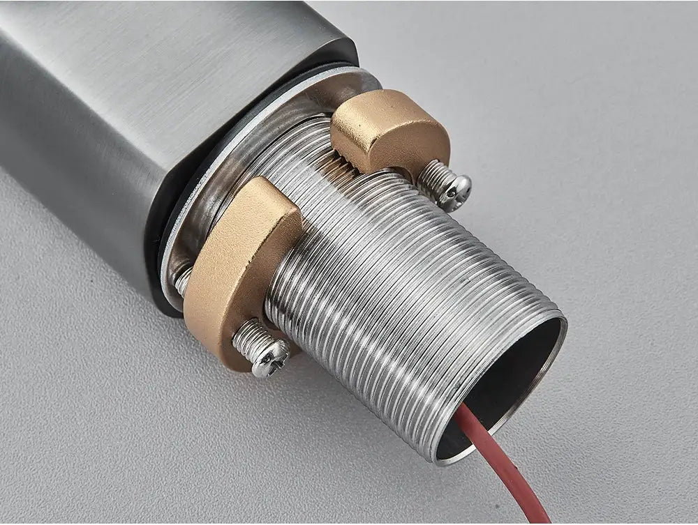 Sensor basin faucet tailpiece with chrome threaded connector, brass mounting nuts, and red wire
