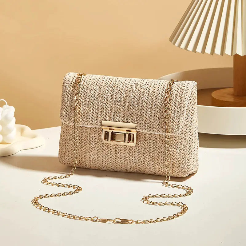 Crossbody bag with beige woven texture and gold-tone chain strap