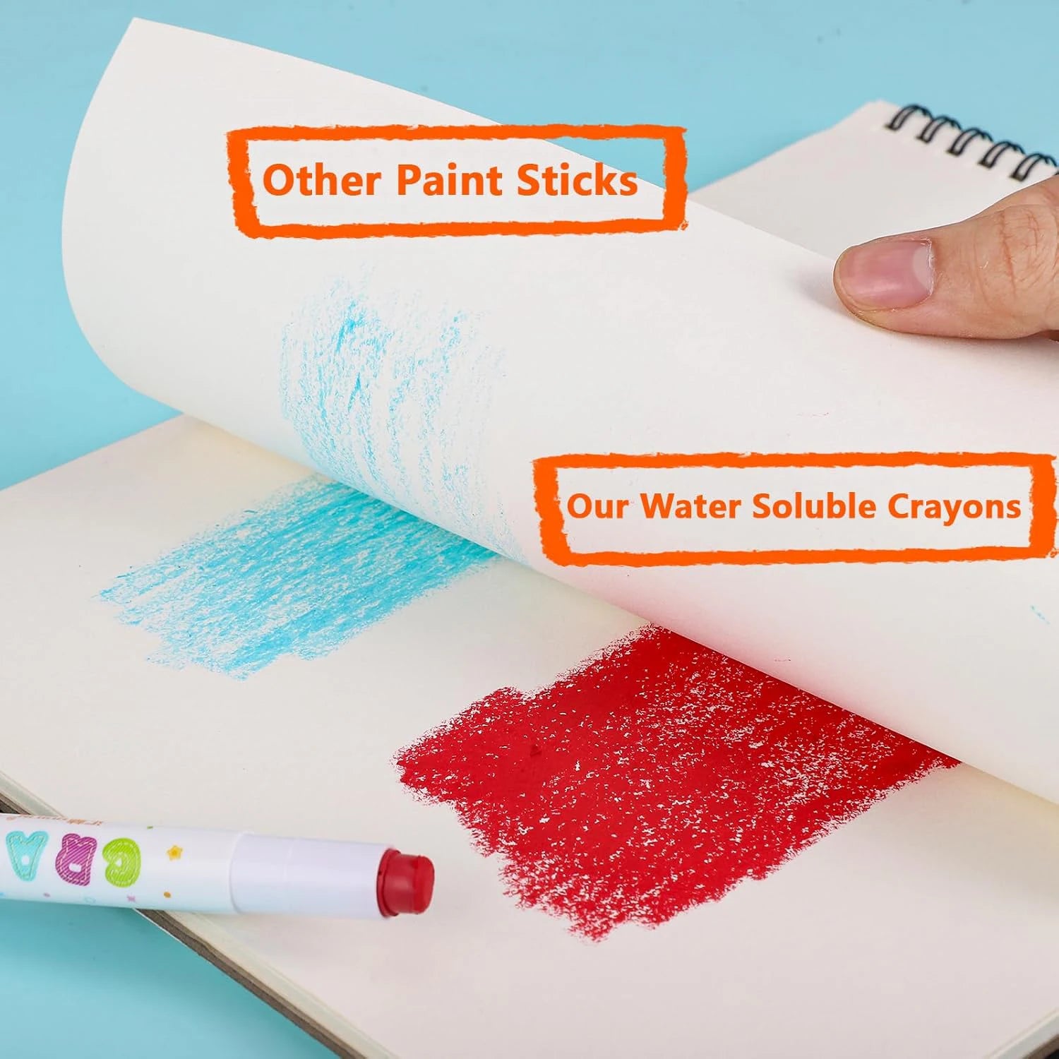 Twistable water-soluble crayons; blue and red swatches on open notebook pages