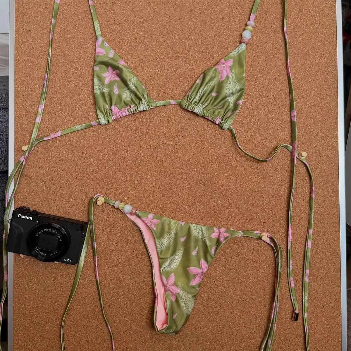 Floral green bikini set, two-piece thong swimsuit with pink flowers and beaded straps.