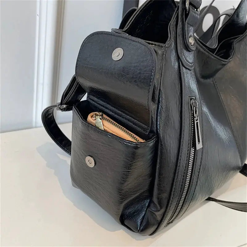 Black PU leather shoulder bag with front snap-pocket and vertical side zipper, silver hardware