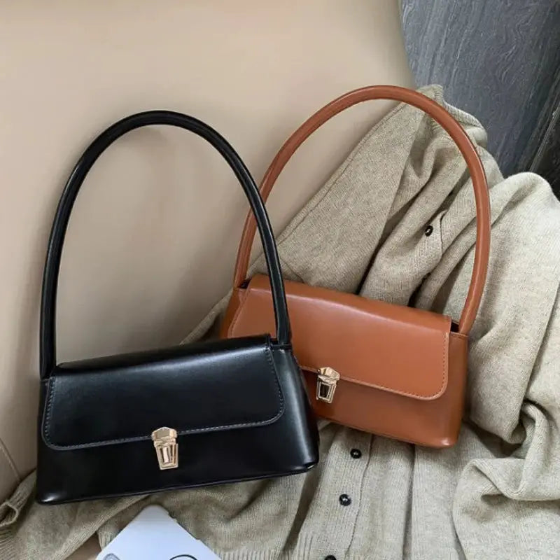 Shoulder bags set: two solid-color retro-style handbags in black and tan with top handles and gold-tone clasps.
