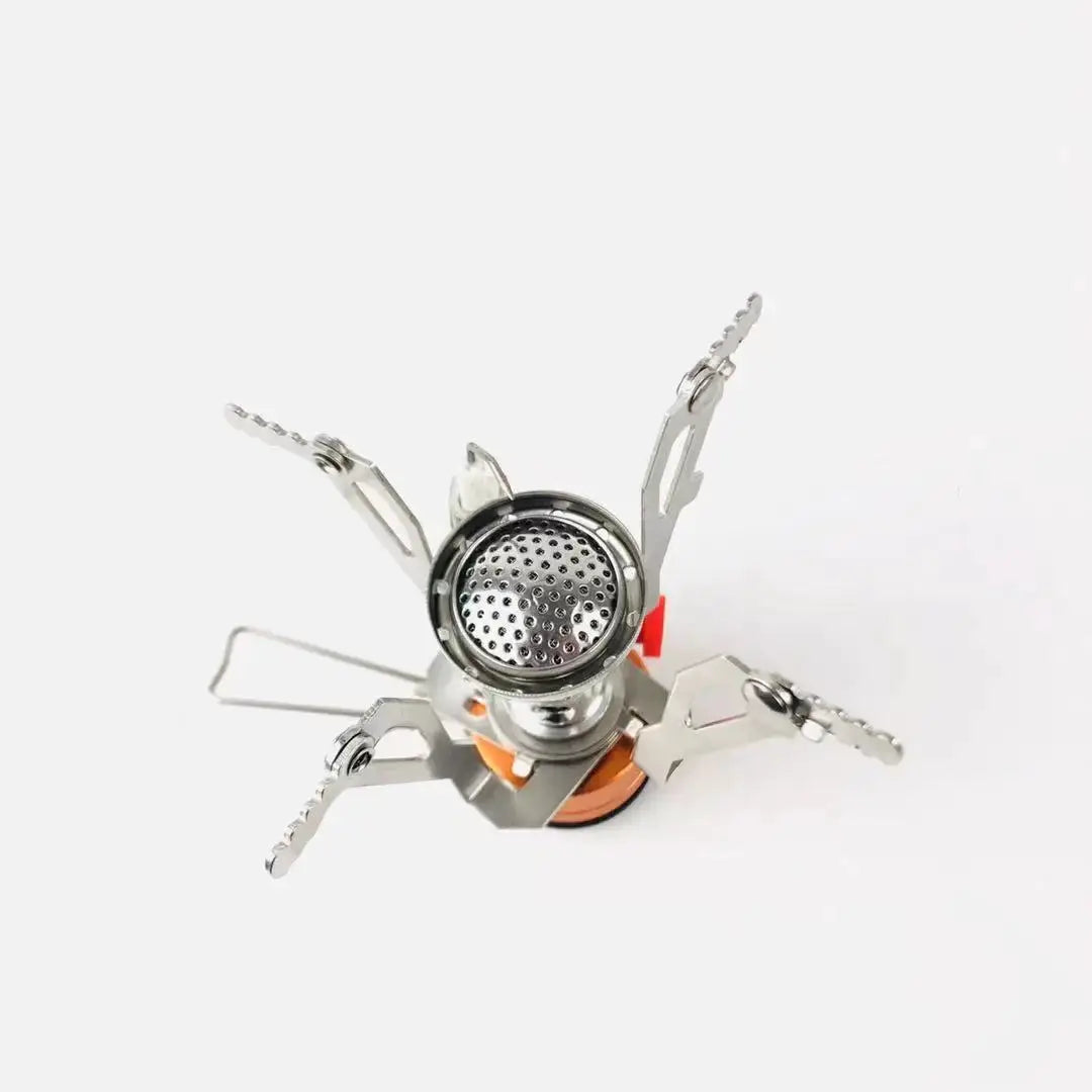Portable aluminum camping stove Simples Market with orange base and legged pot supports