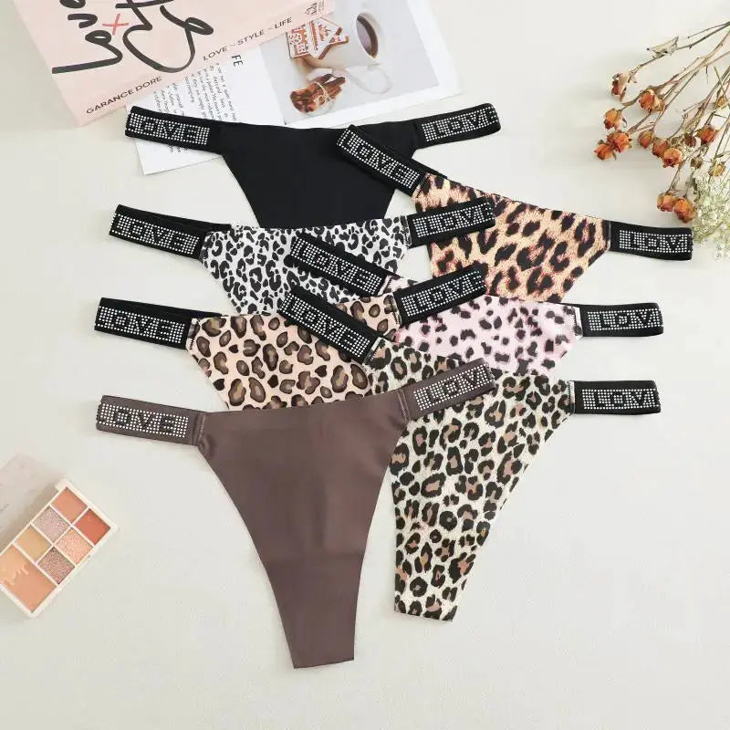 Simples Market 7-piece women's thong set; leopard prints and solid black with low waist and jeweled LOVE waistband