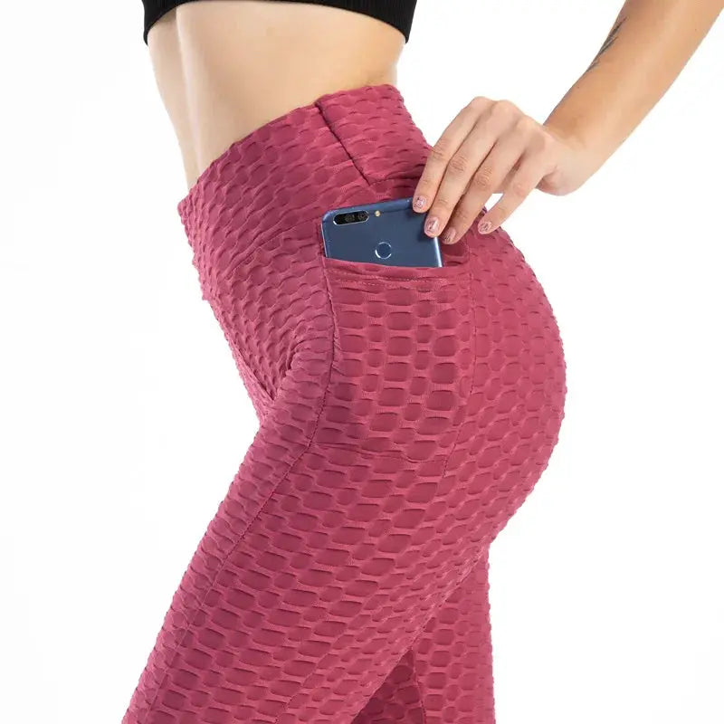 Women’s pink bubble-textured high-waist leggings with a side pocket for phone.
