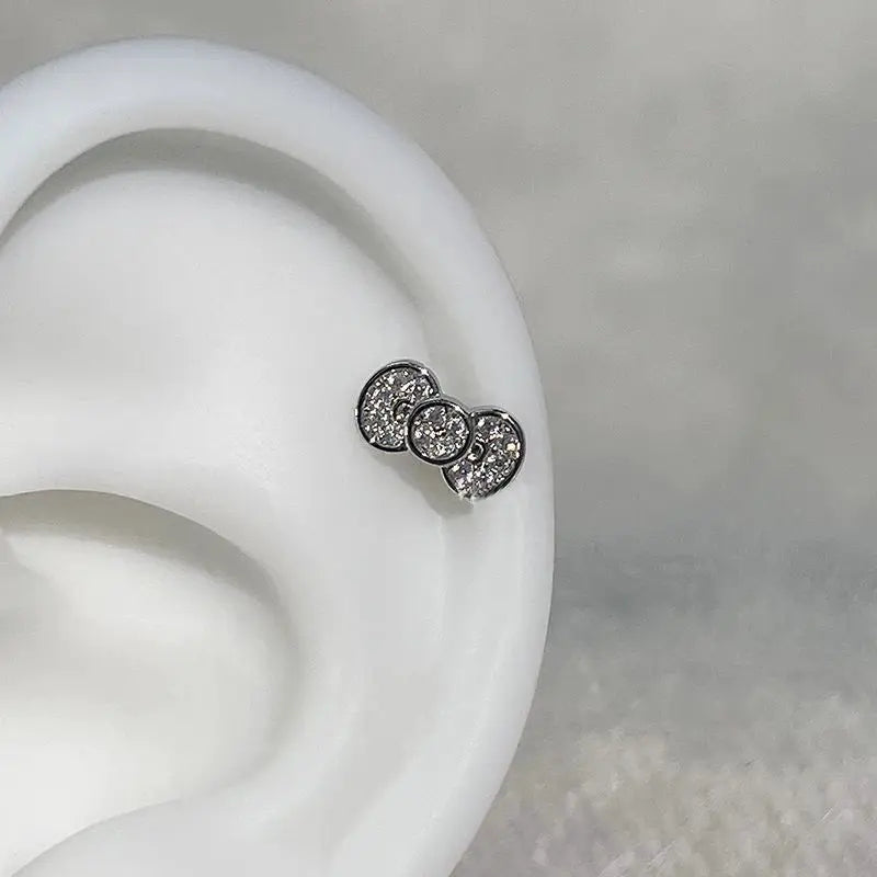 316L stainless steel annular ear bone nail earring with three linked zircon stones.