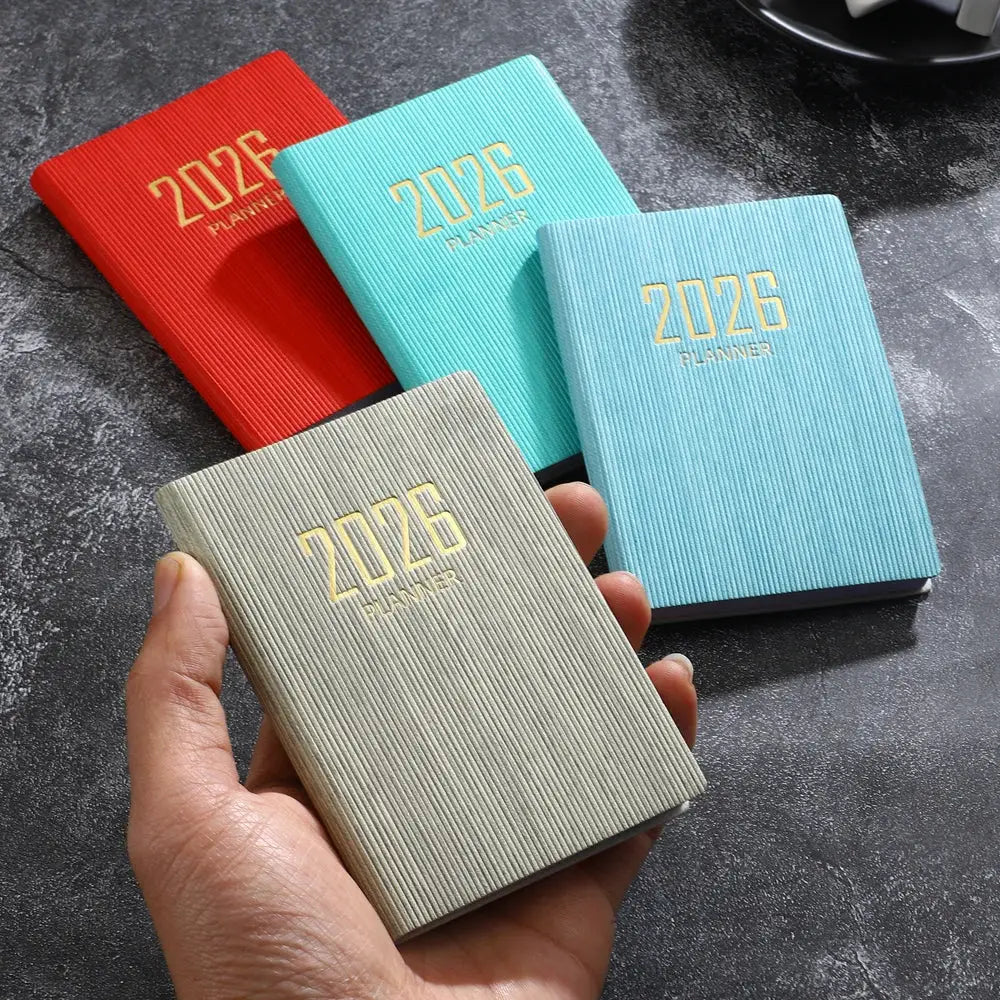 A7 pocket planner by Simples Market, 2026, four colorful ribbed covers in red, turquoise, light blue and gray