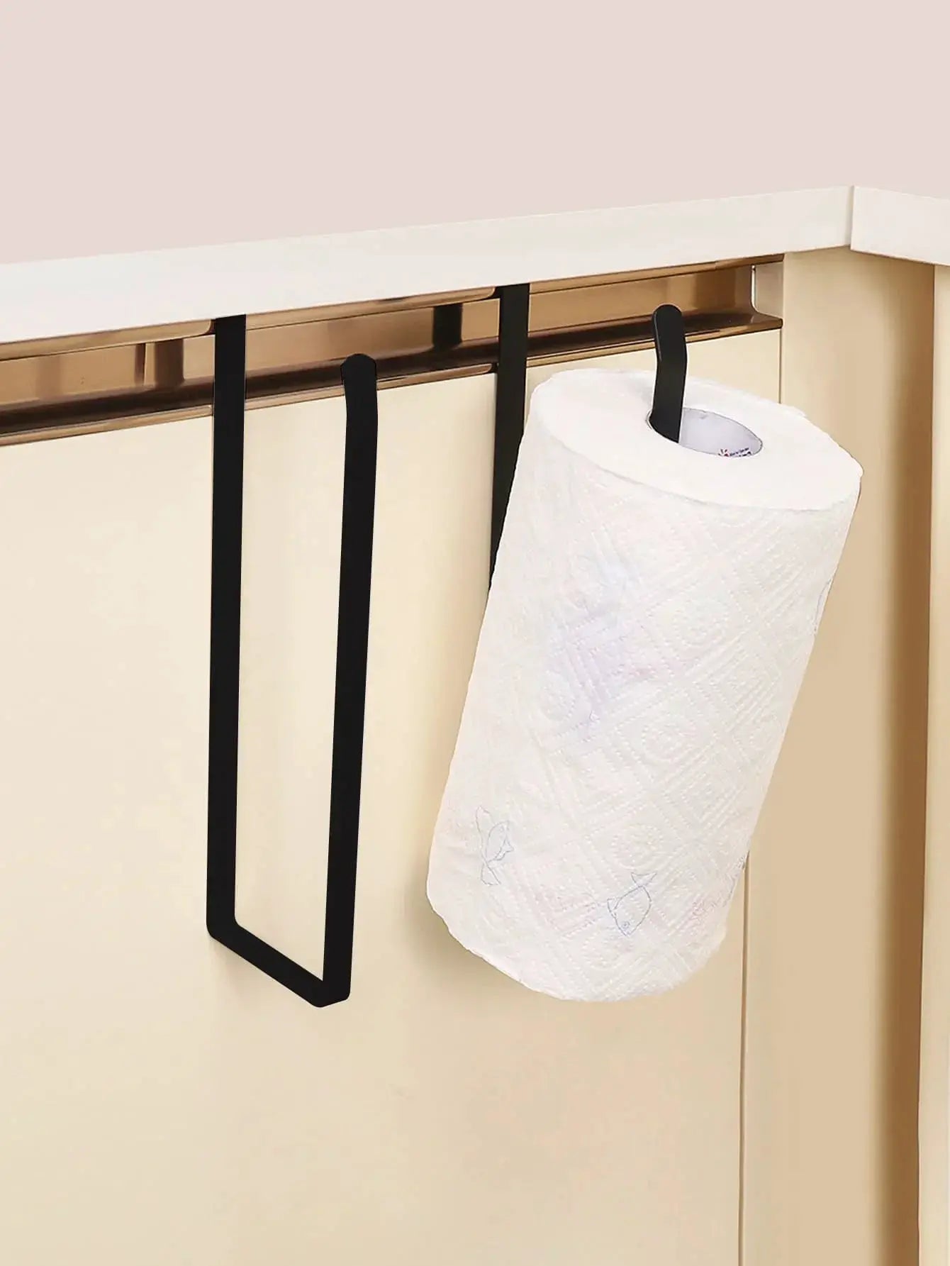 Paper towel holder, black metal hanging wall rack holding a white paper towel roll.