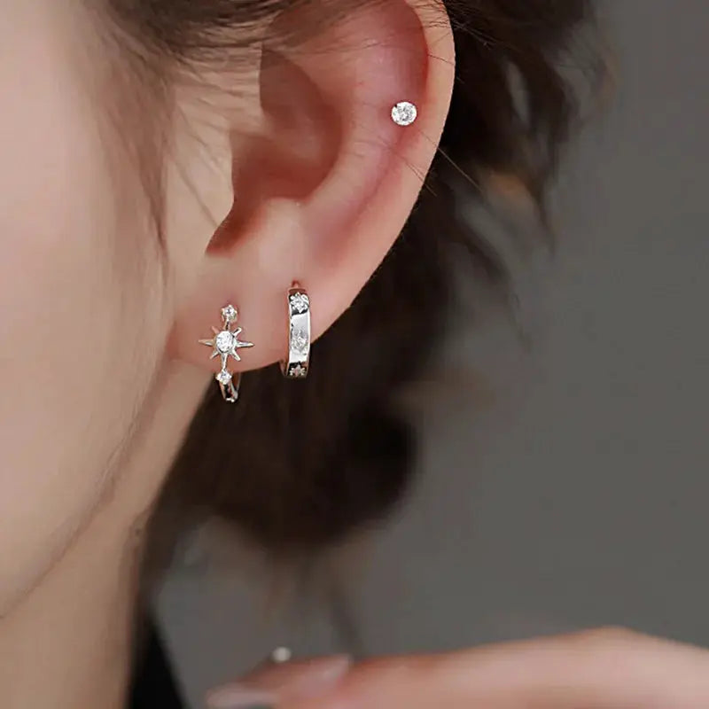 Simples Market 925 sterling silver zircon star asymmetry hoops; three earrings visible on ear.