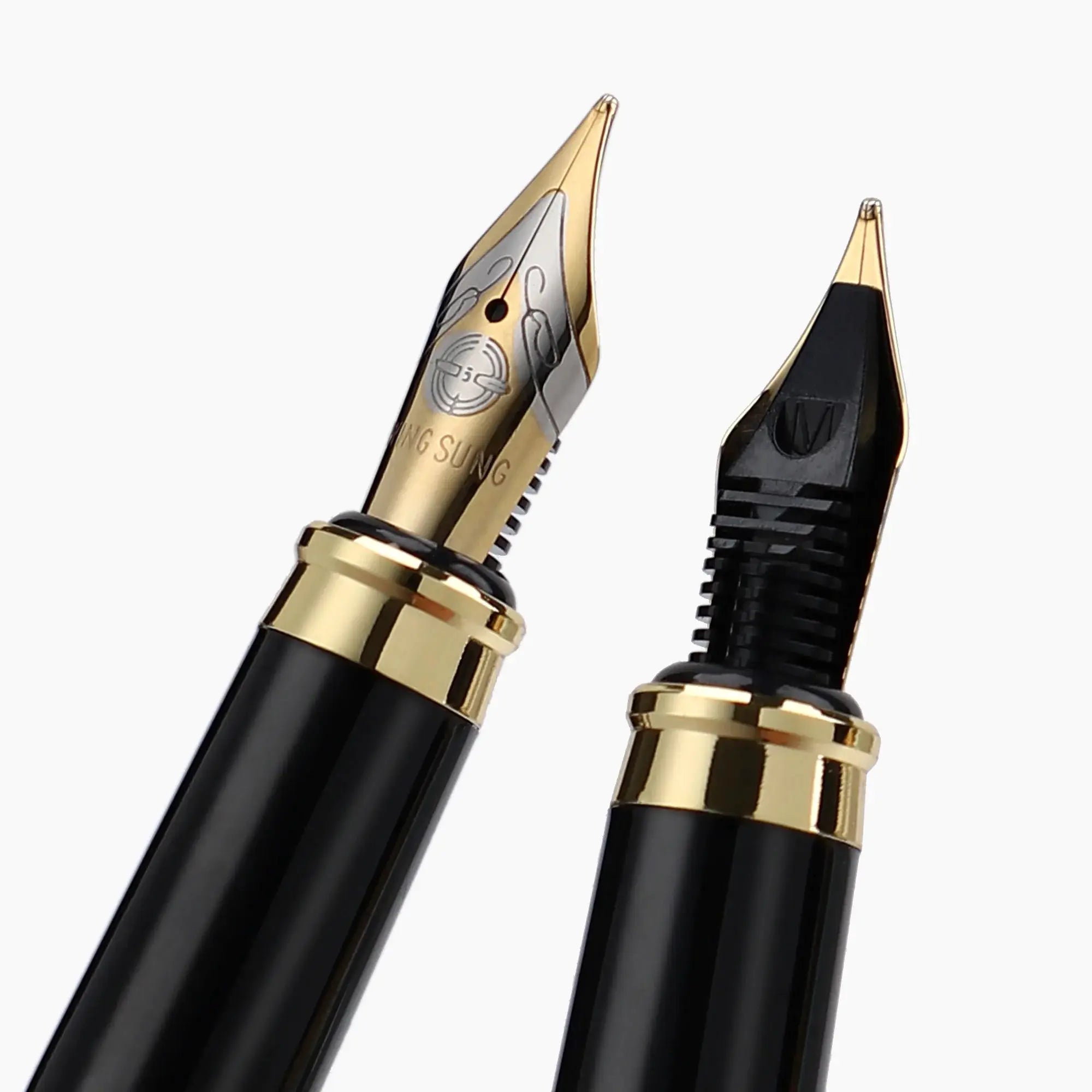 Two black fountain pens with gold nibs and trim, close-up of nib tips.