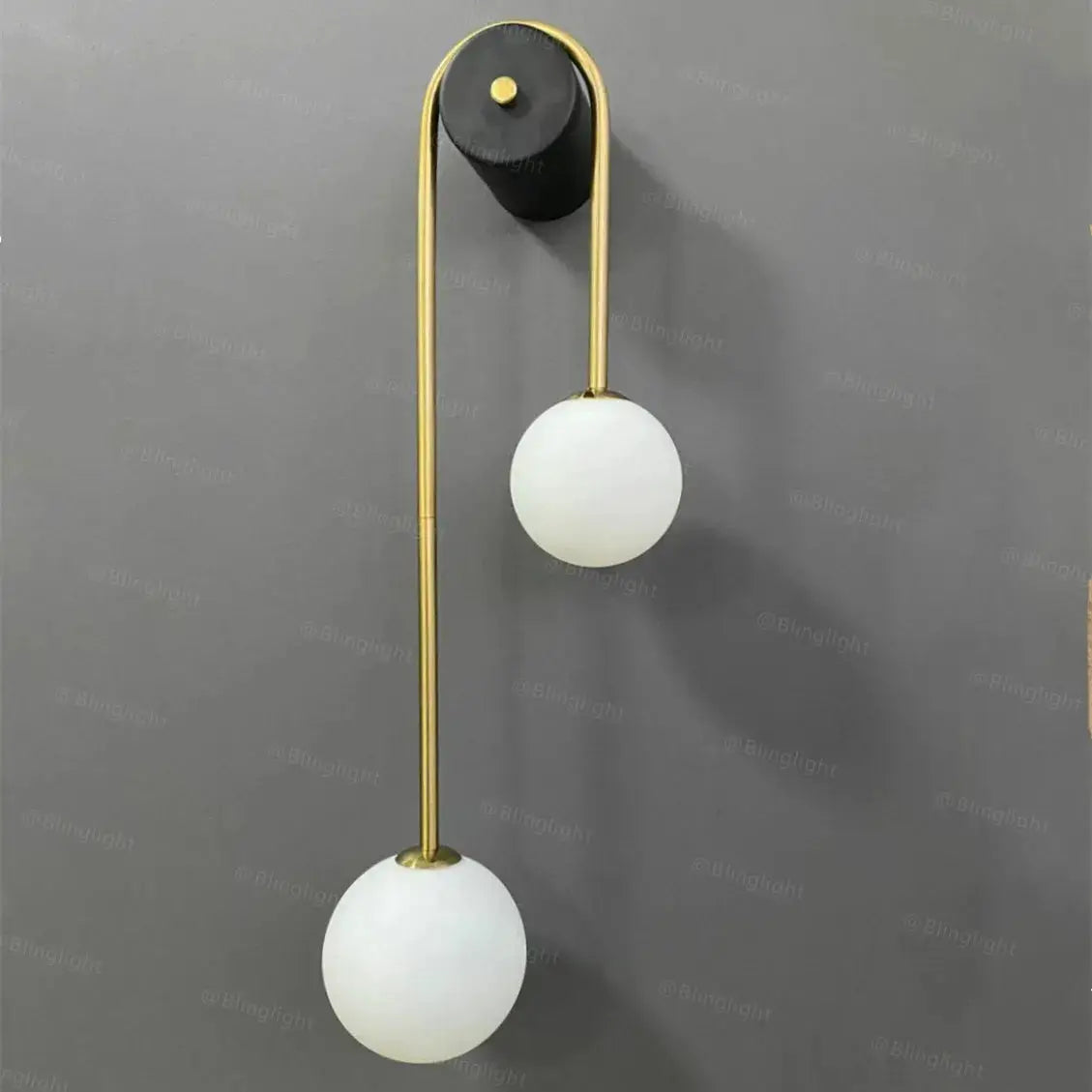 Modern wall lamp with dual glass globe shades on a curved gold brass stem LED living room sconce