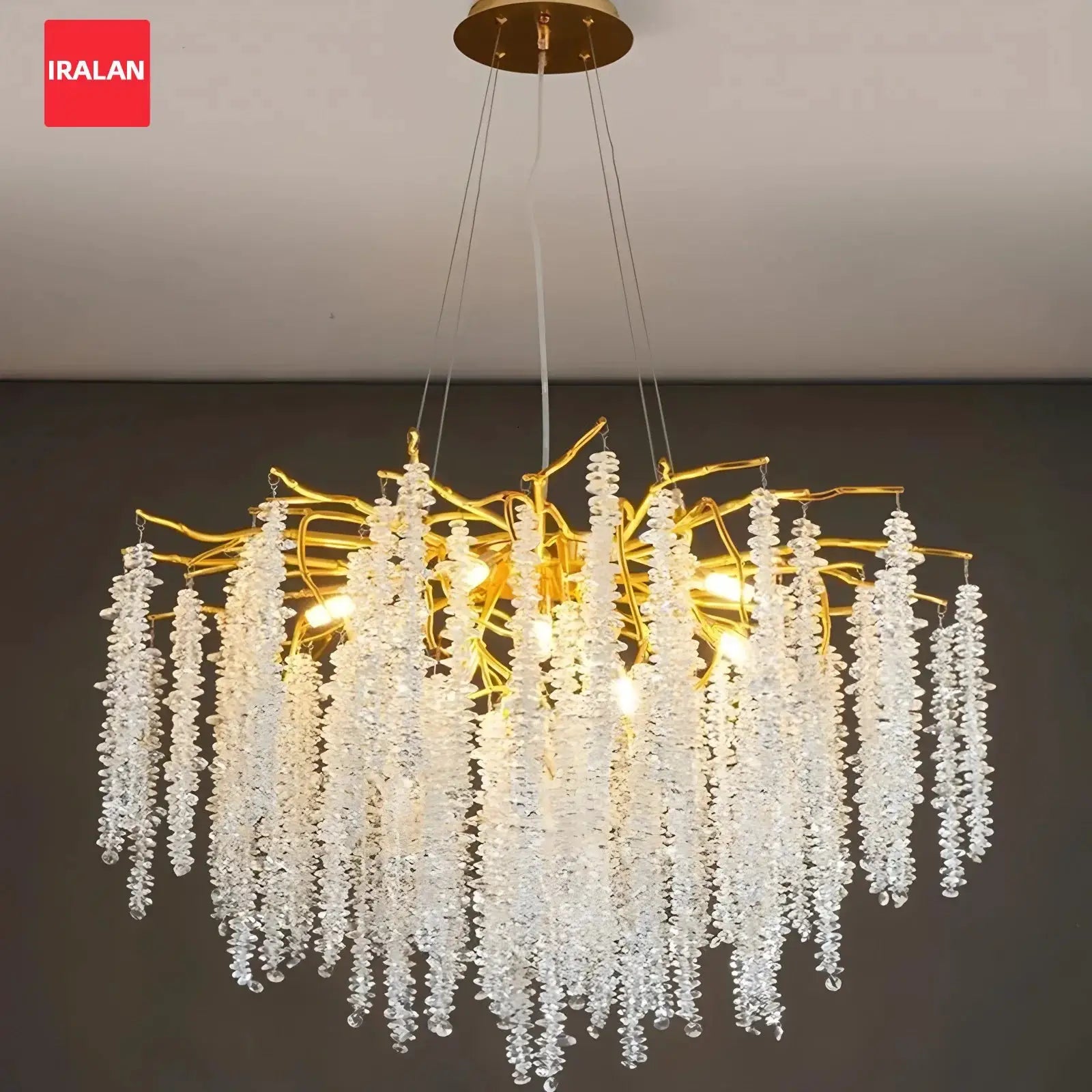 Crystal chandelier pendant light with gold branches and clear crystal droplets, IRALAN logo visible