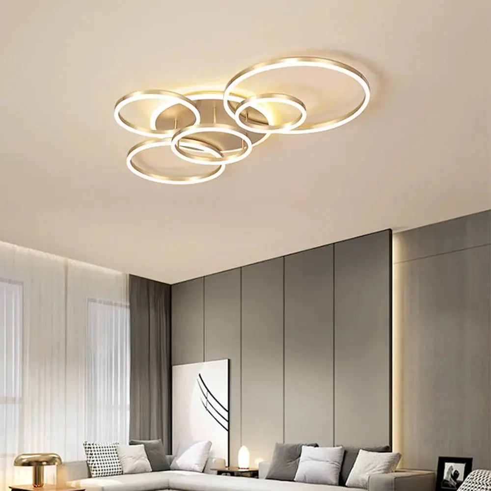 Modern LED ceiling chandelier with overlapping circular rings in gold finish, ideal for living room decor.