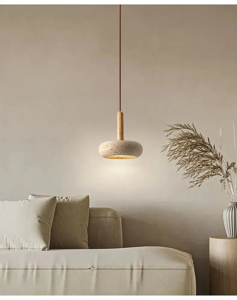 2025 Wabi Sabi circular yellow stone LED pendant lamp by Simples Market with wood stem, hanging over a beige sofa.
