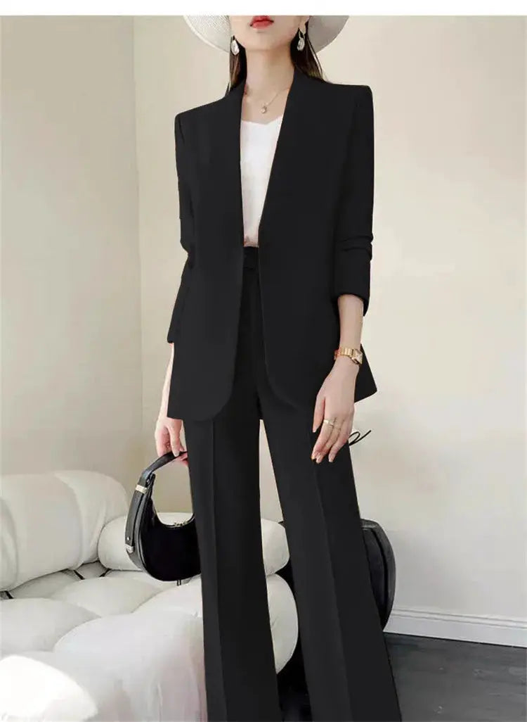 Black two-piece women's suit set with blazer and wide-leg pants; white top visible
