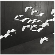 Seagull-design LED pendant lamp by Simples Market with multiple white curved bird-like shades