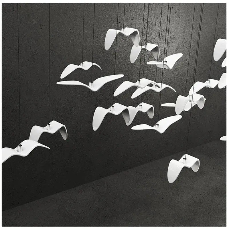 Seagull-design LED pendant lamp by Simples Market with multiple white curved bird-like shades