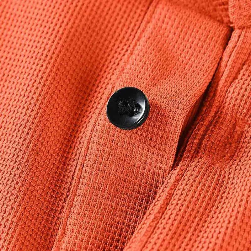 Men's polo shirt in bright orange knit with black button detail.