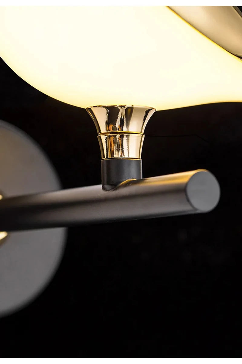 Modern LED wall lamp with gold collar and black arm, white shade