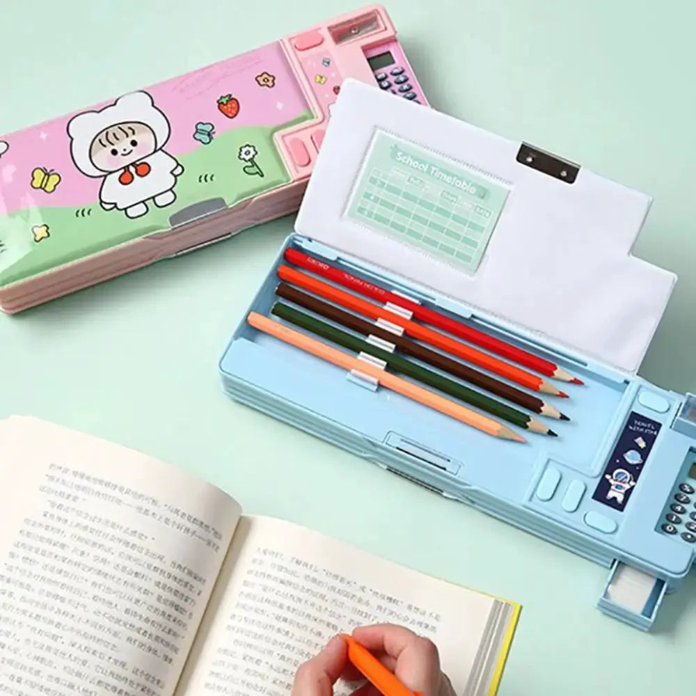 Two plastic pencil cases: blue double-sided case with built-in calculator and sharpener; pink cartoon pencil box nearby
