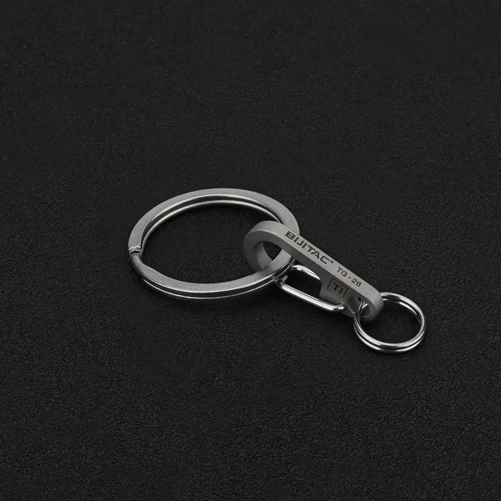 Simples Market titanium alloy key ring with 18mm buckle-style tag and small split ring, metallic grey