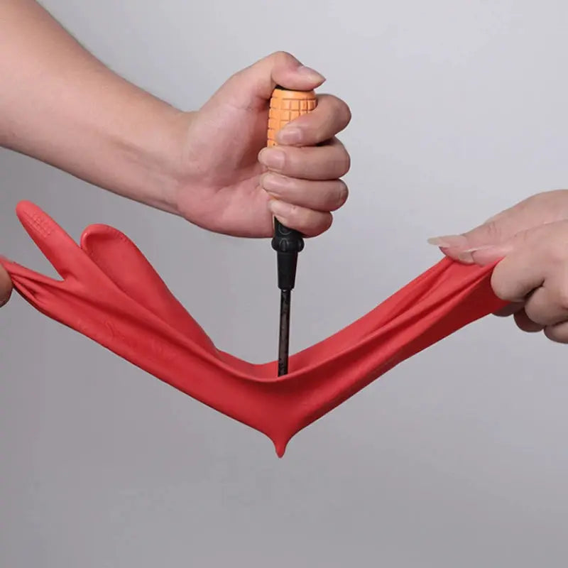 Red silicone dishwashing gloves pair being stretched by hands with an orange textured grip tool