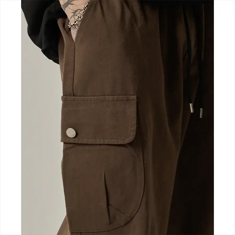 Men's brown cargo pants with large side pocket flap and button, drawstring waist