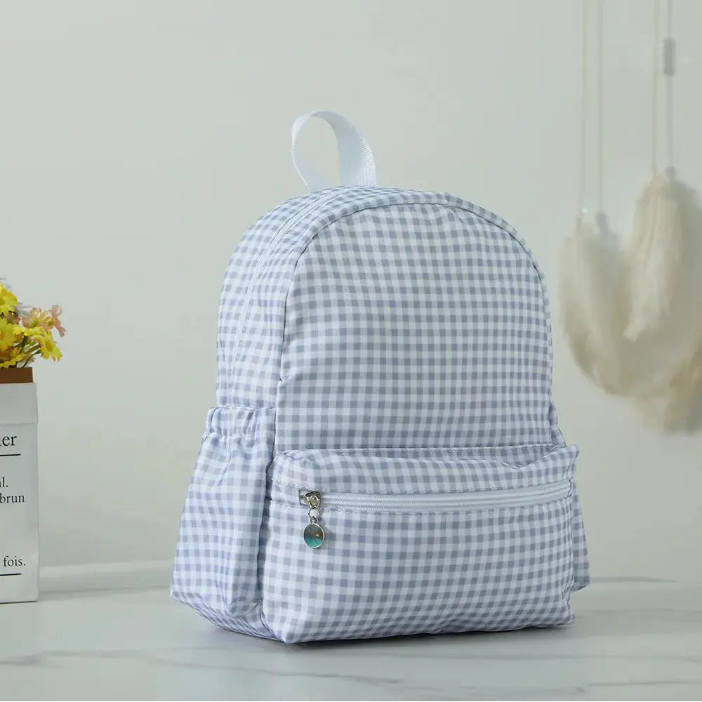 Toddler backpack in light blue gingham with front zip pocket and top handle