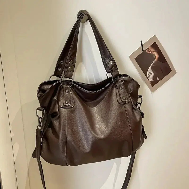Soft interior compartment shoulder bag in brown PU leather with dual handles