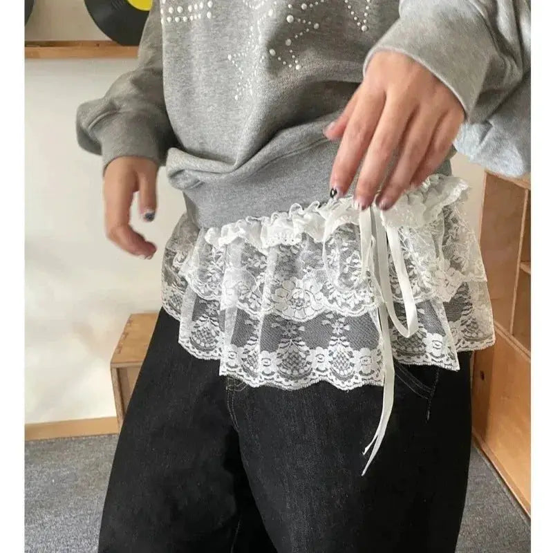 White lace layered mini skirt with floral pattern and satin ribbon tie at the waist