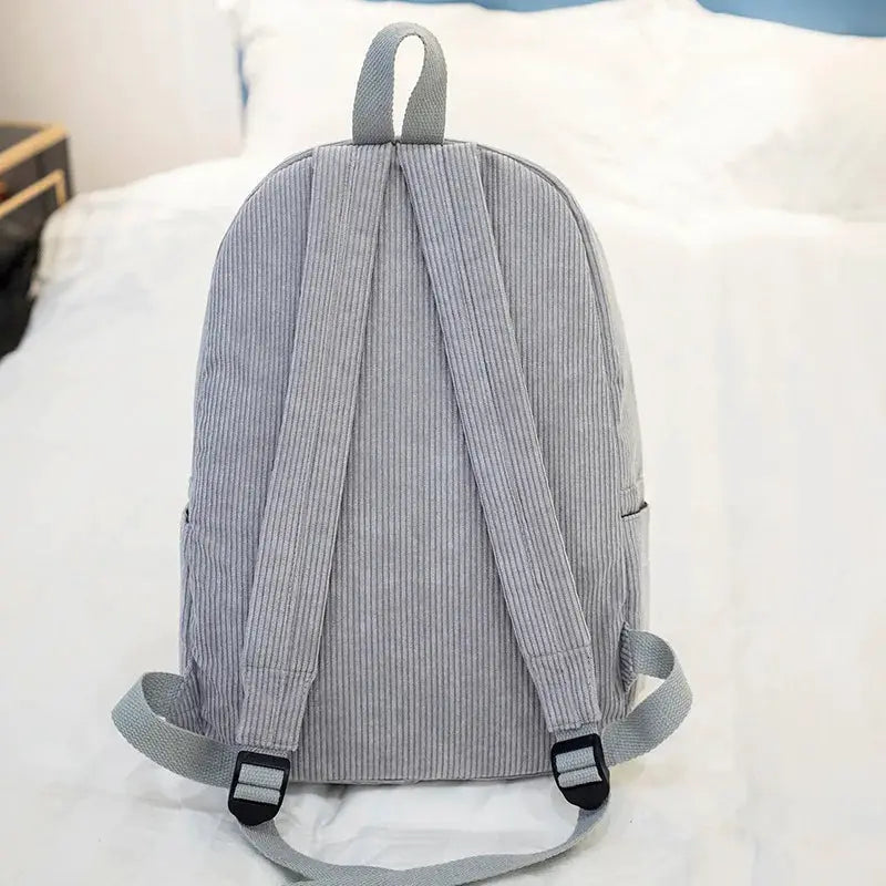 Personalized kids backpack by Simples Market in grey corduroy with adjustable straps.
