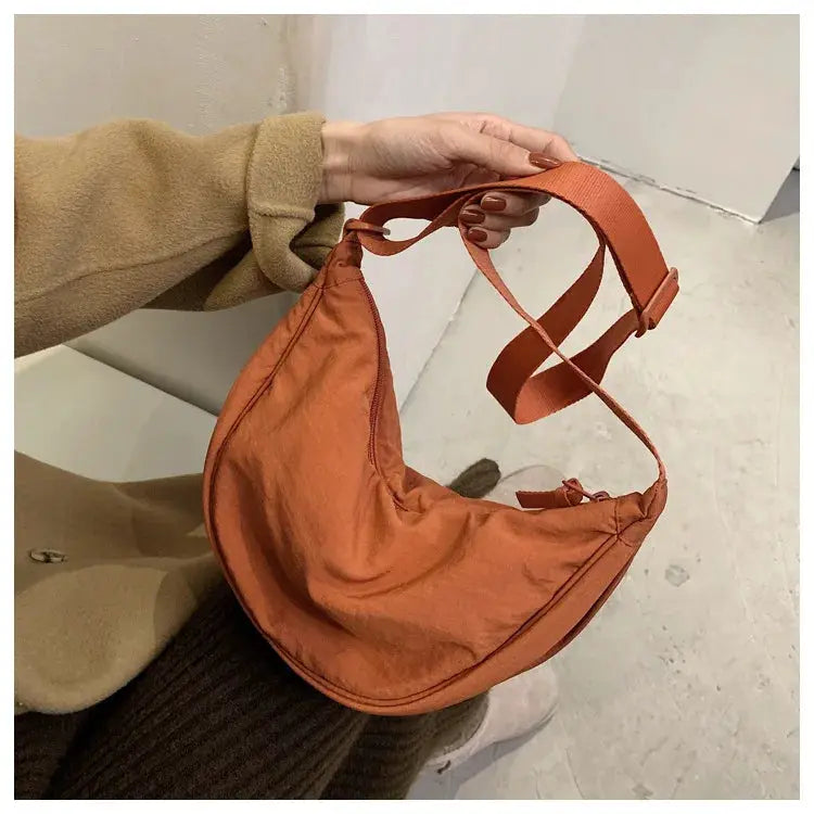 Casual nylon hobo crossbody bag by Simples Market in rust orange with adjustable strap and large capacity