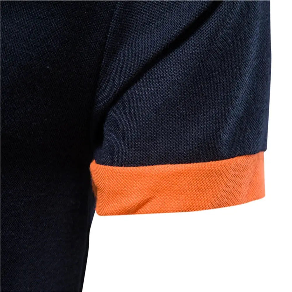 Men's polo shirt; navy knit with orange cuff, short sleeves.