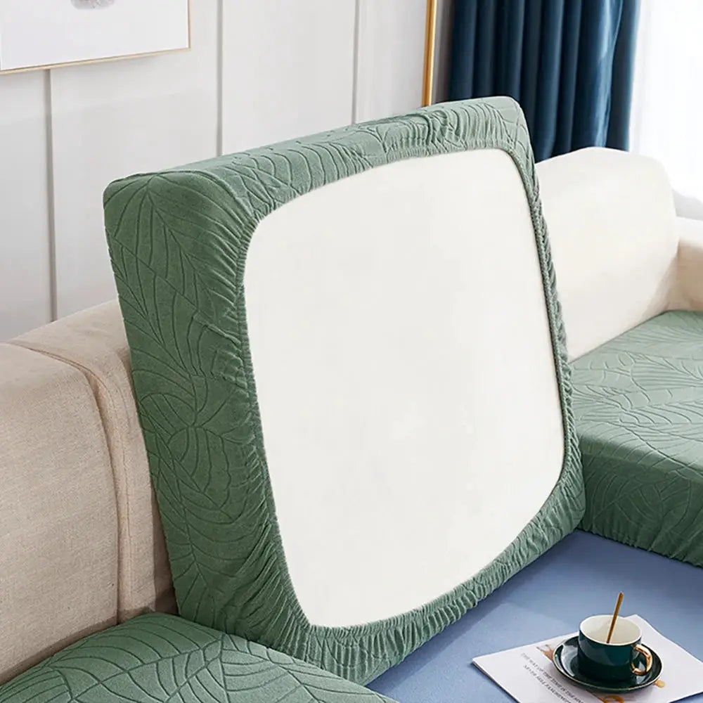 Waterproof stretch sofa cushion cover in green jacquard fabric, removable protector for chaise lounge.
