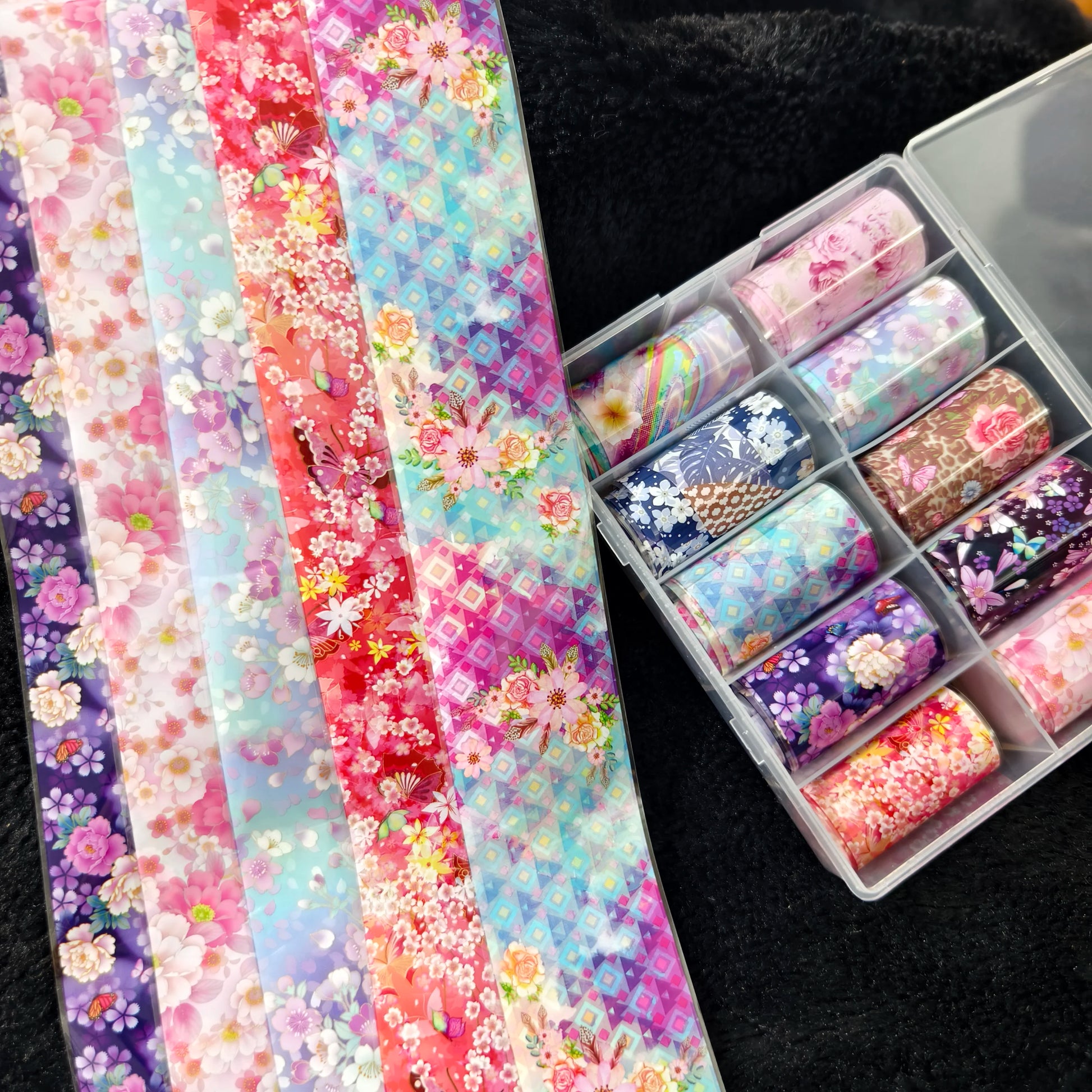 Nail foil transfer sheets in floral, plaid, marble, and geometric designs; 10 rolls in a clear organizer