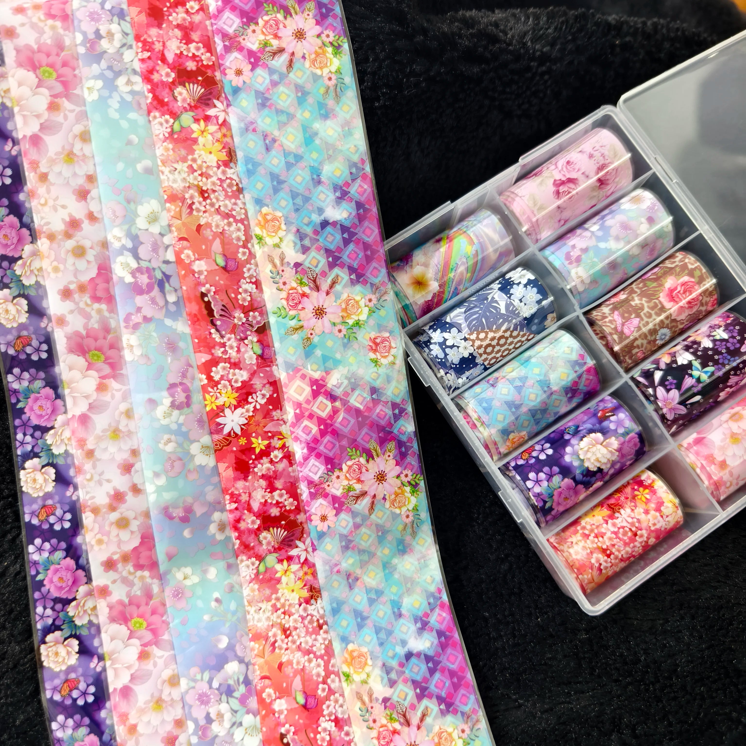 Nail foil transfer sheets in floral, plaid, marble, and geometric designs; 10 rolls in a clear organizer