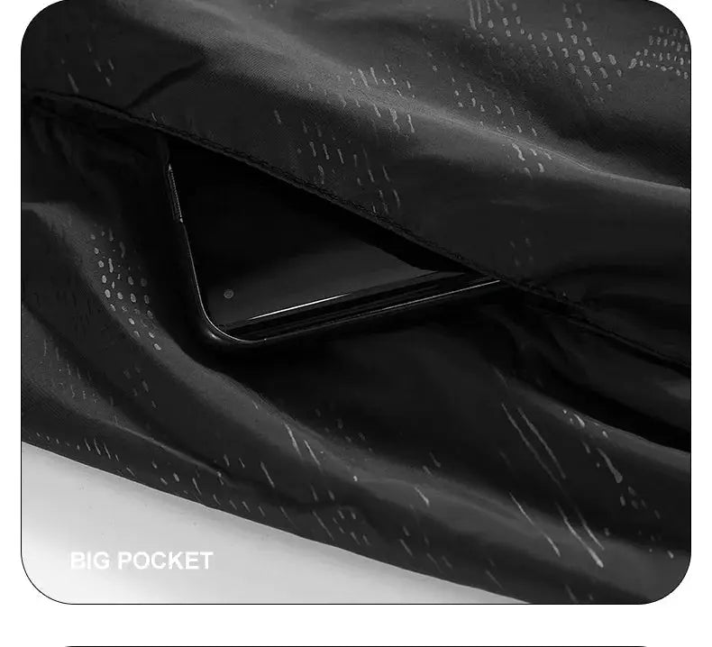 LNGXO waterproof hiking jacket, black unisex windbreaker with a big pocket holding a phone