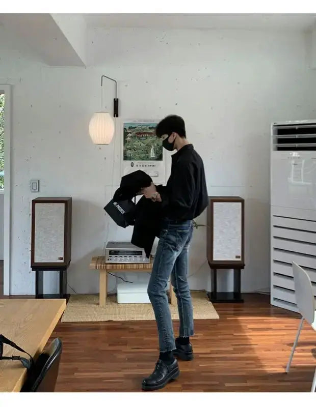 Men's black solid-color cardigan, slim-fit, long-sleeve in a modern interior setting