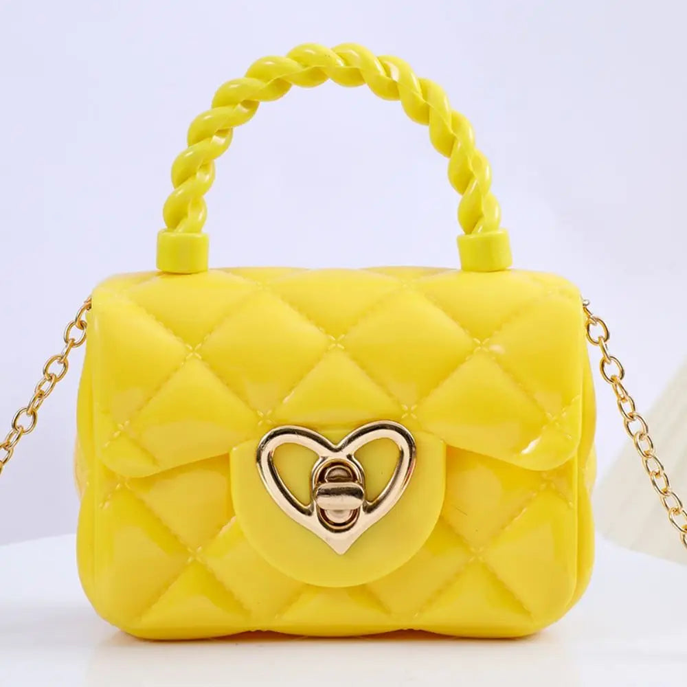 Kids yellow PU leather quilted crossbody bag by Simples Market with heart clasp and chain strap